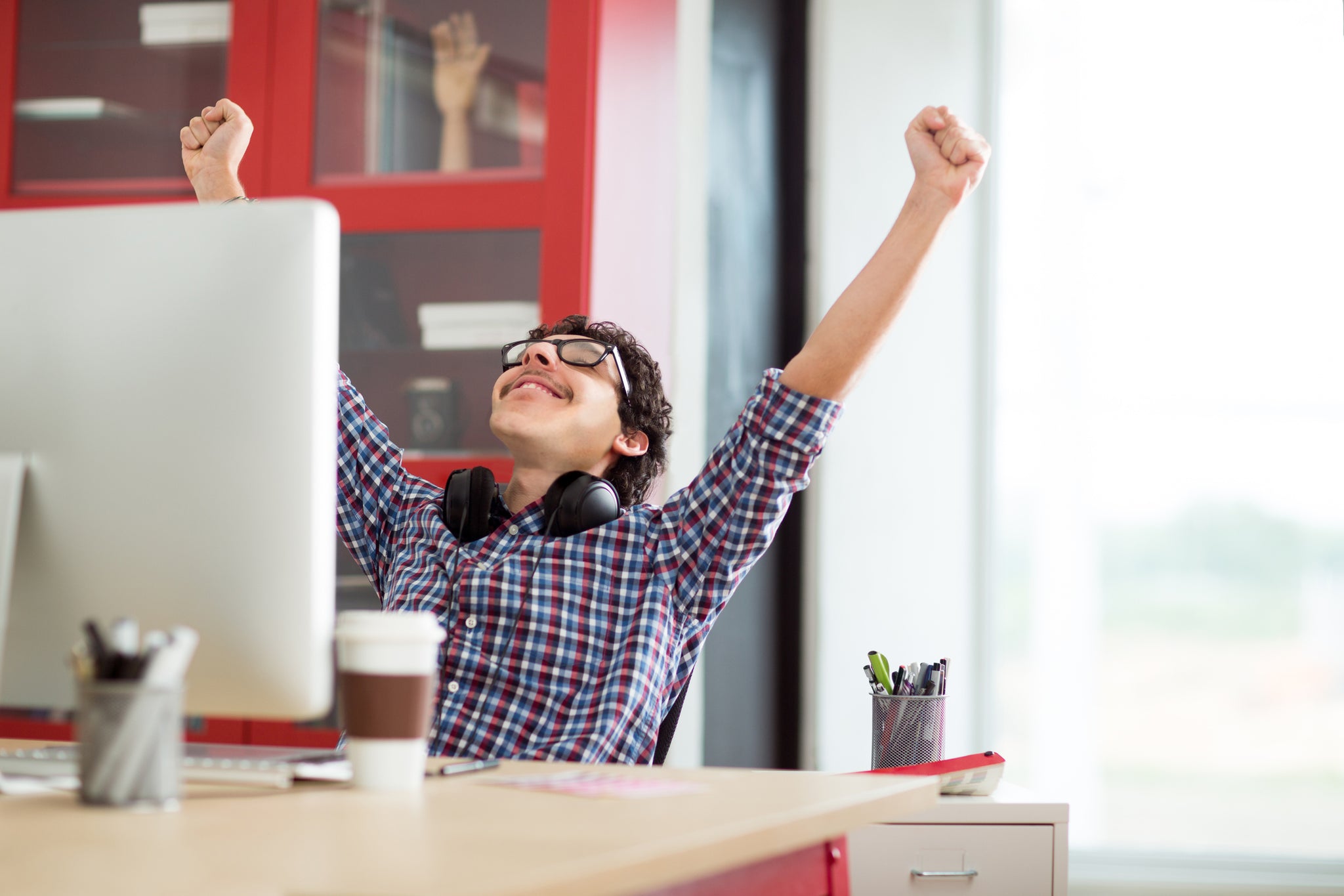 Worker celebrating at desk